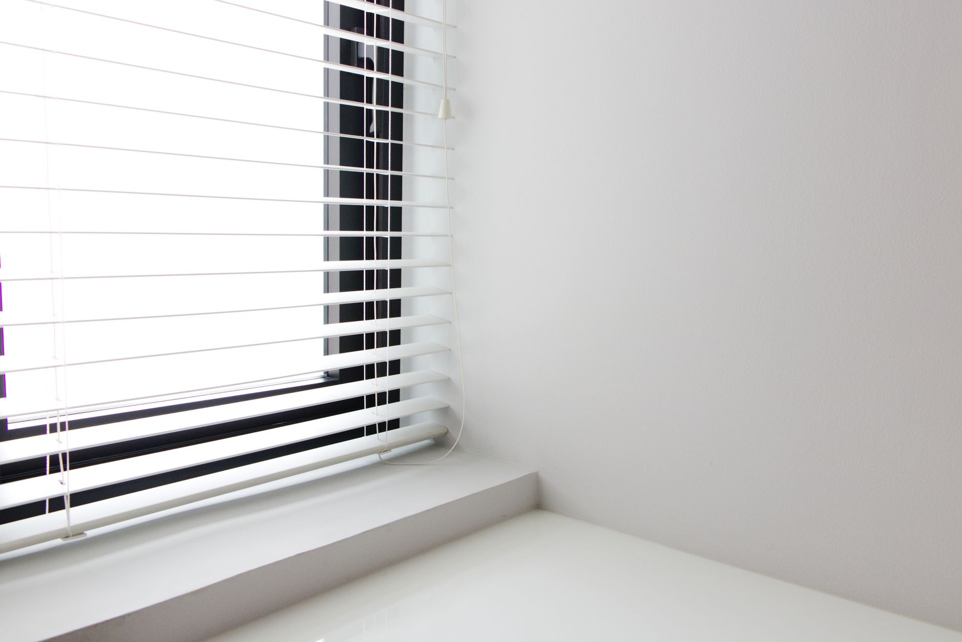 Bright minimalist interior with white window blinds and smooth wall, perfect for modern design